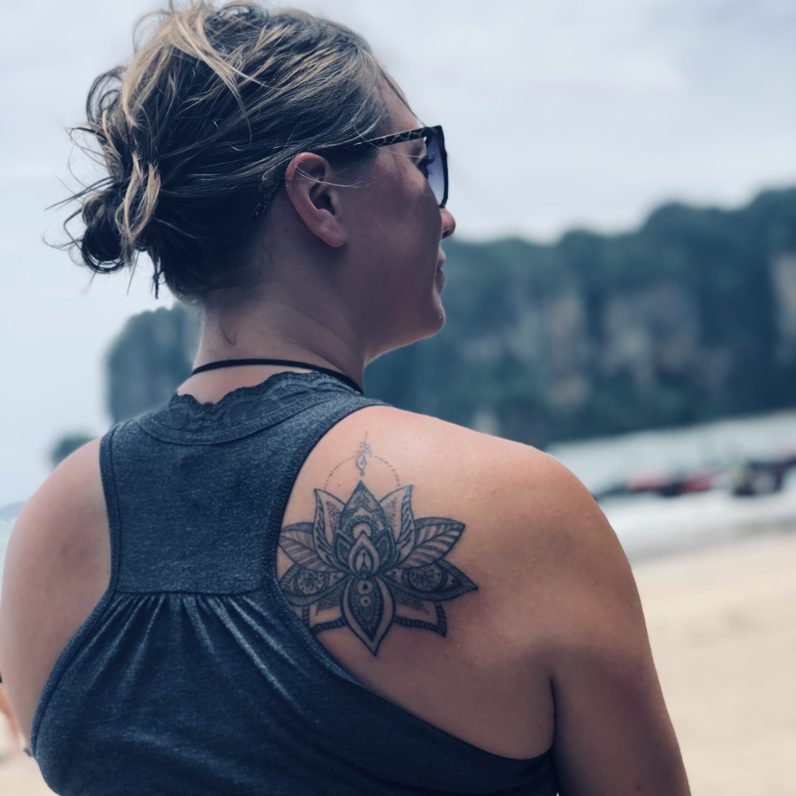 Photo of Ginny Dee seen from behind, looking off to the right with a moody, dramatic filter—representing disorientation and transition during early sobriety.