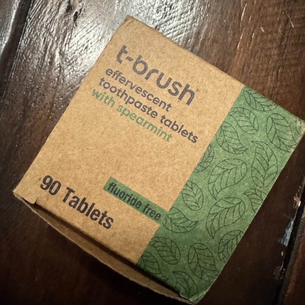 T-brush natural toothpaste tablets in travel-friendly jar, compact eco-friendly alternative to toothpaste tube