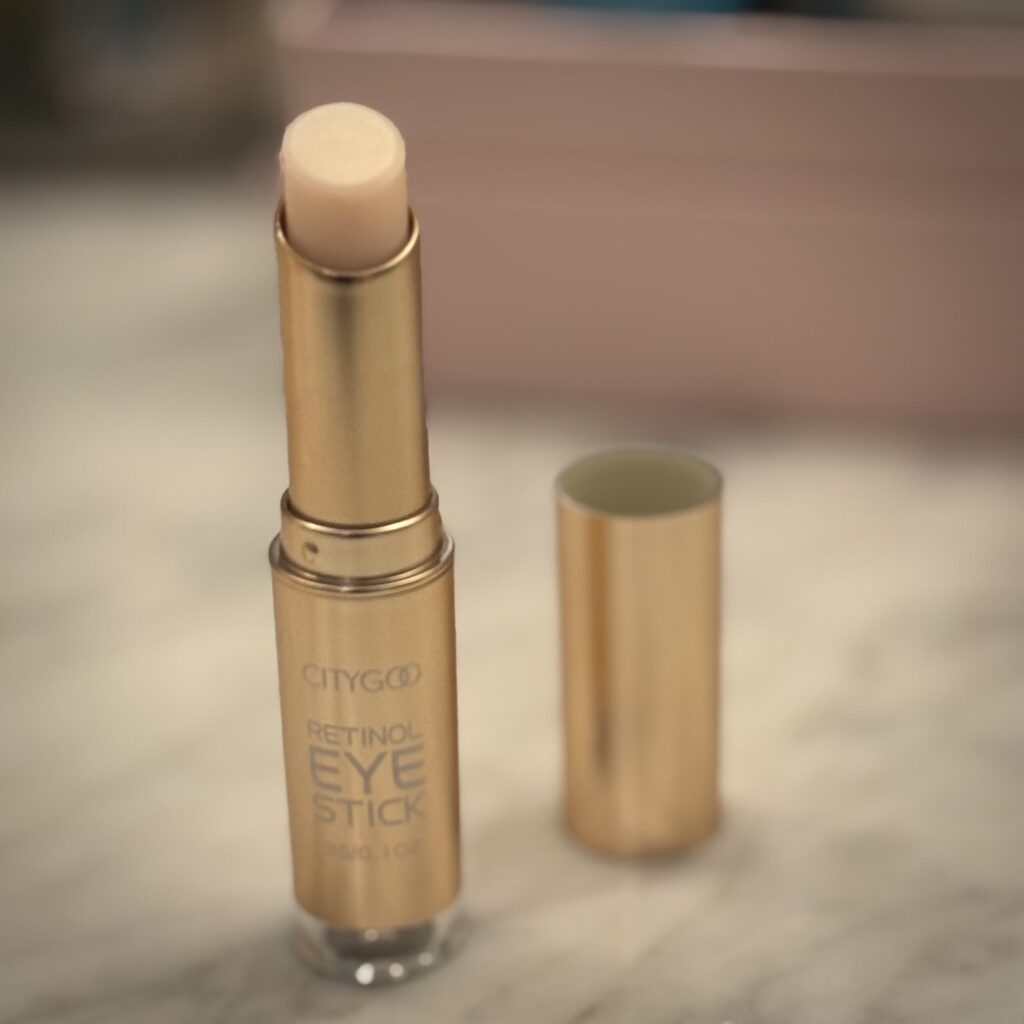 City Goo Retinol Eye Serum Stick photographed by Ginny Dee, compact lipstick-sized solid eye moisturizer for travel skincare.