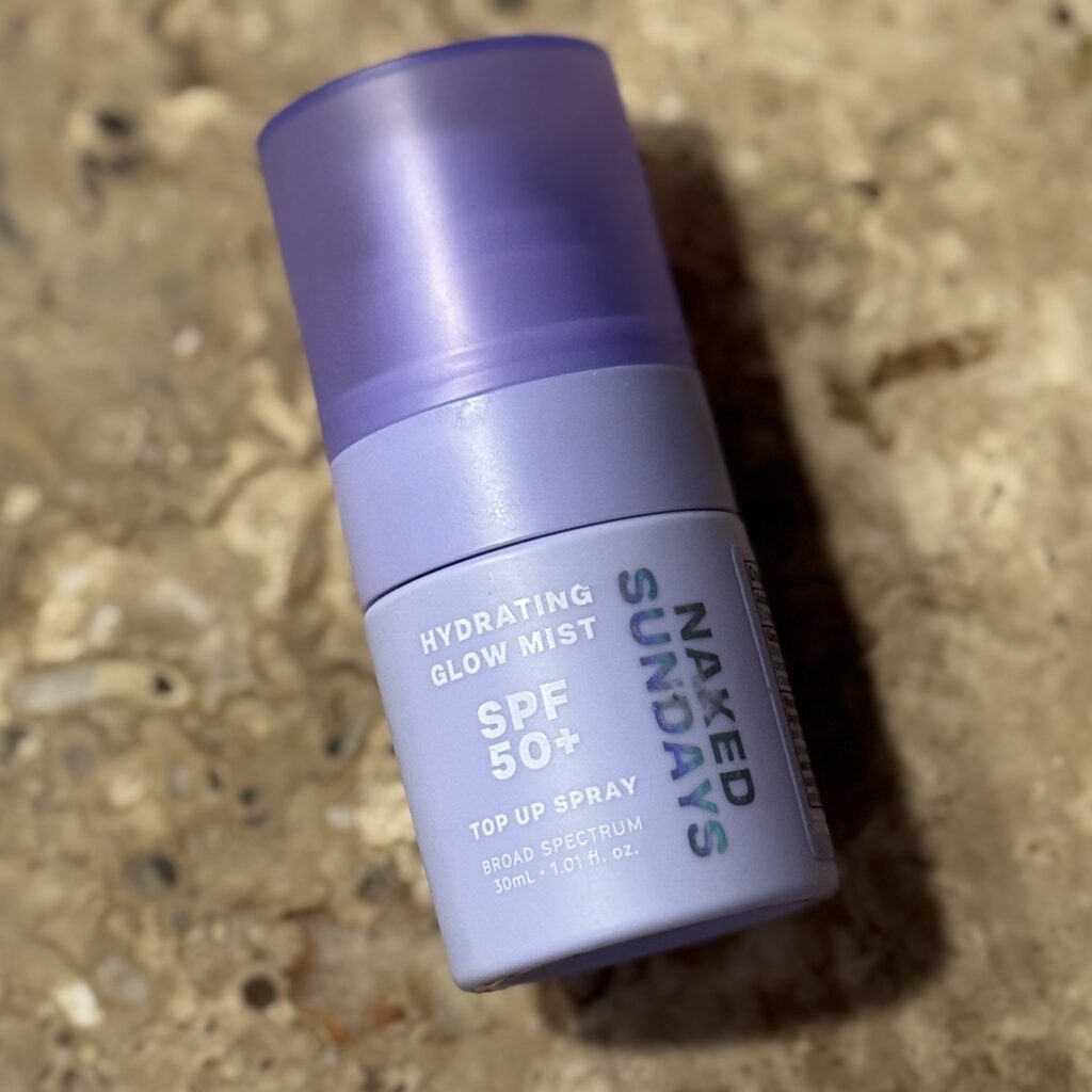 A pretty little purple bottle of Naked Sundays Hydrating Glow Mist SPF 50+ for a pretty little glowing face.