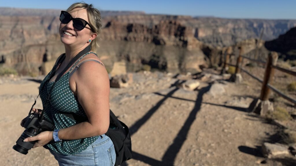 Ginny Dee at the Grand Canyon, camera in hand—solo, sober, and storytelling.