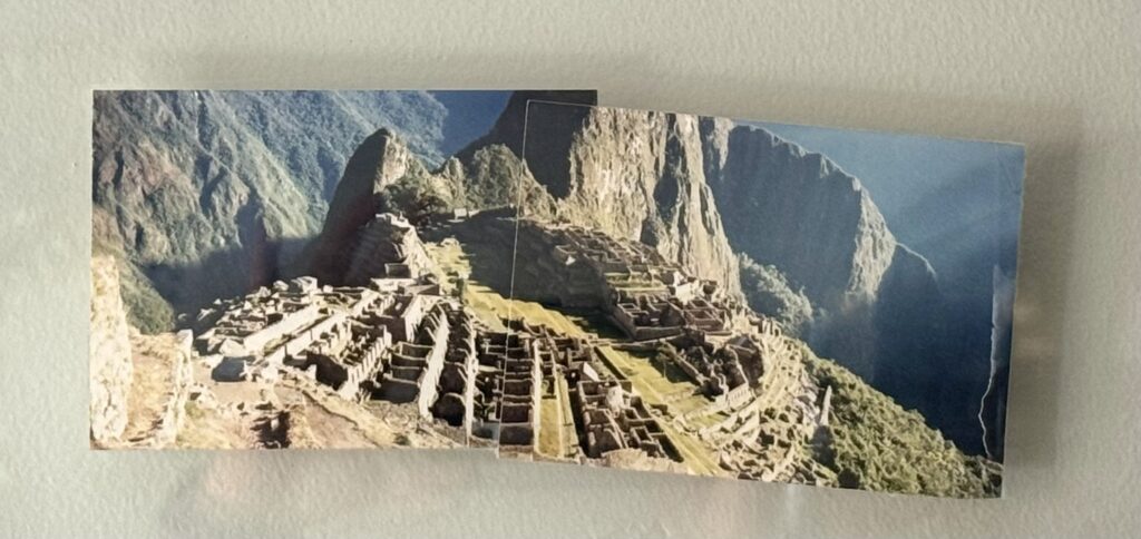 Two joined photographs of Machu Picchu taken in 1997, showing stone terraces and dramatic mountain scenery.