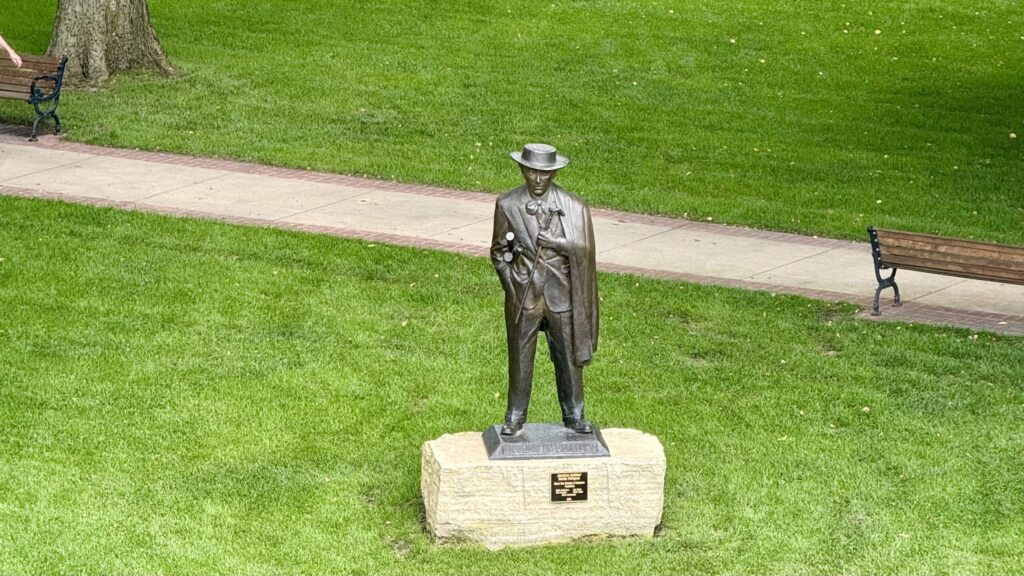 Overhead view of the Frank Lloyd Wright statue in Central Park, Mason City, facing the Historic Park Inn across the street.