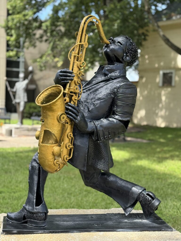 Playful saxophonist statue outside Music Man Square, Mason City.