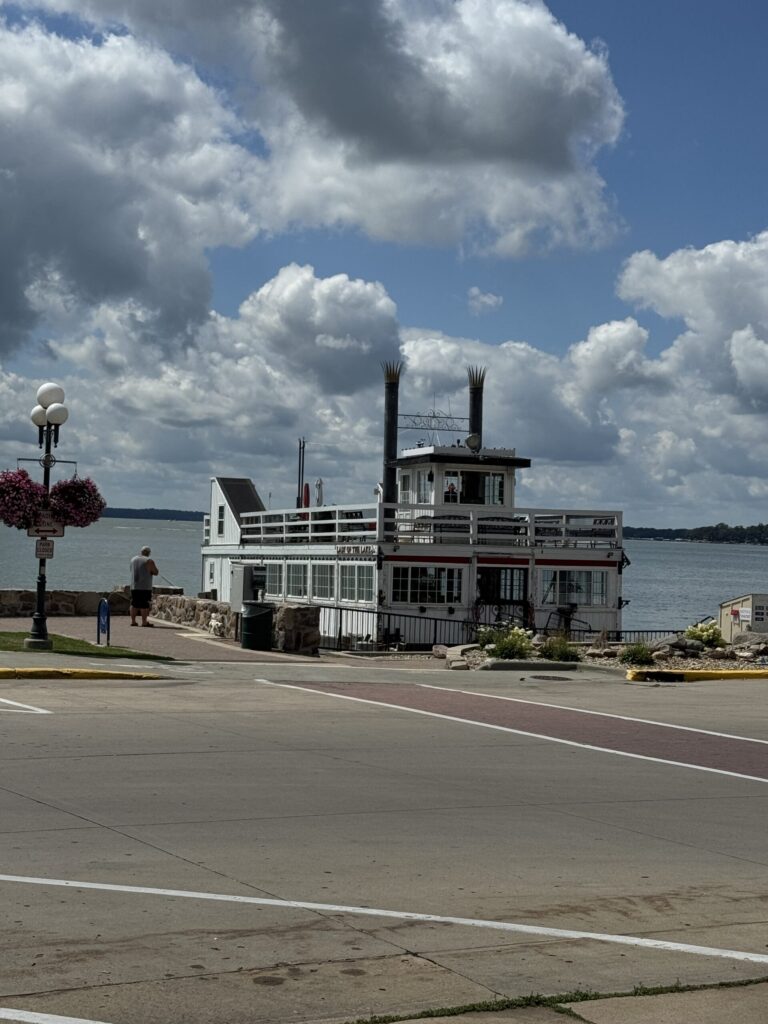 Clear Lake waterfront with a steamboat under big summer clouds.