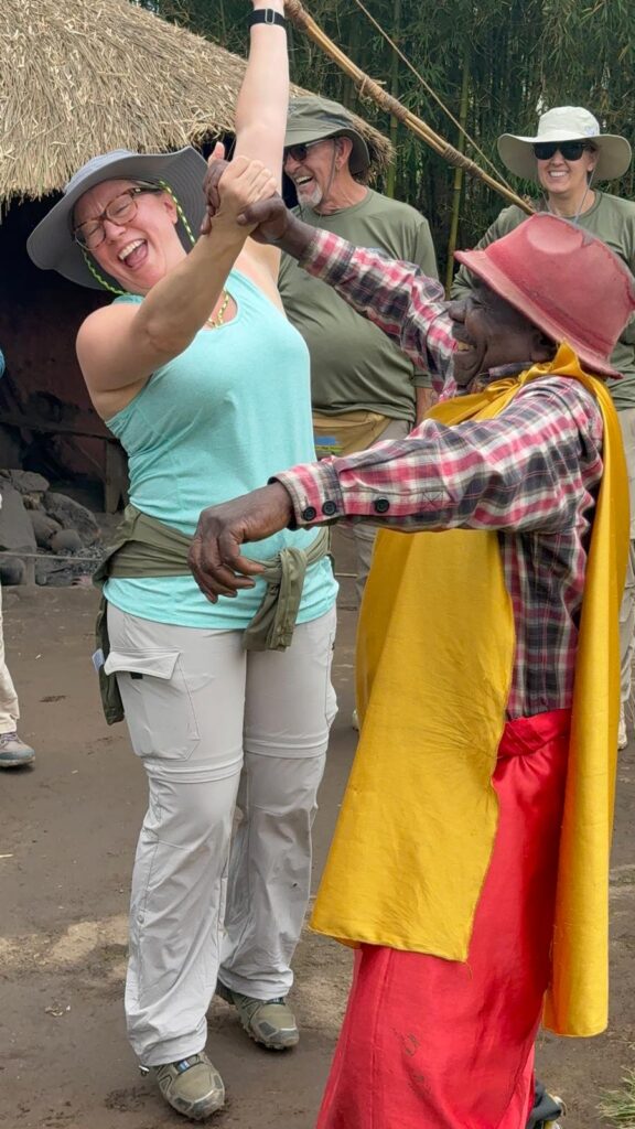 Ginny celebrates after successfully shooting an arrow AND hitting the target surprisingly well in a cultural village in Rwanda.