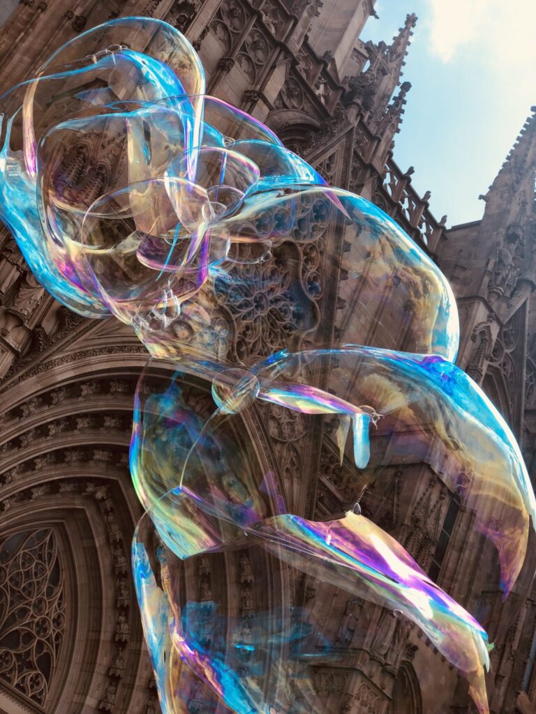 Large, colorful bobbles float in front of Barcelona Cathedral.