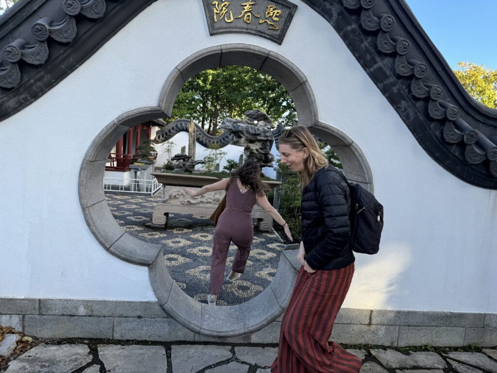 Ginny's gals are acting silly in front of the beautiful, curving wall and shaped gate into the Japanese Gardens at the Jardin Botanique de Montréal.