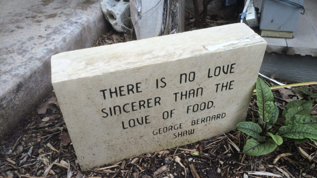 Garden stone with inscription:  "There is no love sincerer than the love of food."  George Bernard Shaw